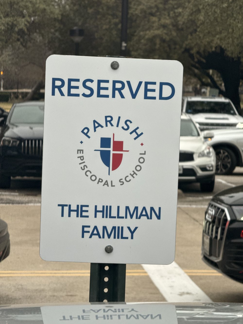 Reserved parking sign at Parish Episcopal School in Dallas, designated for The Hillman Family